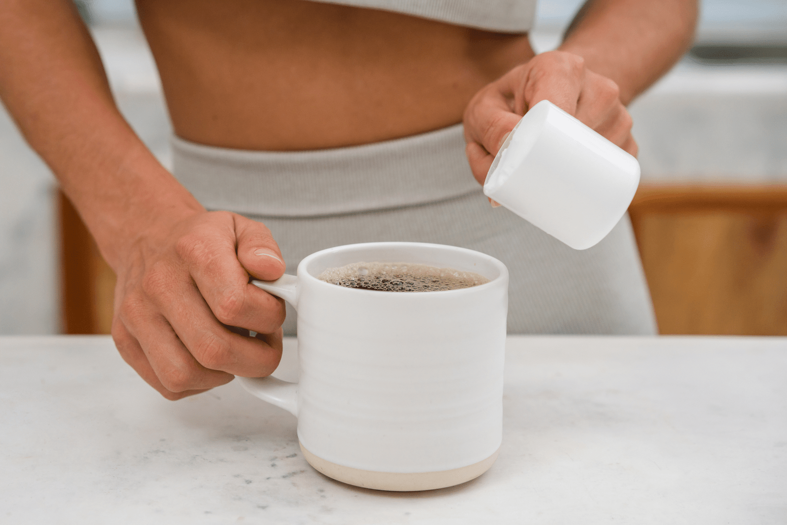 Person preparing protein coffee.