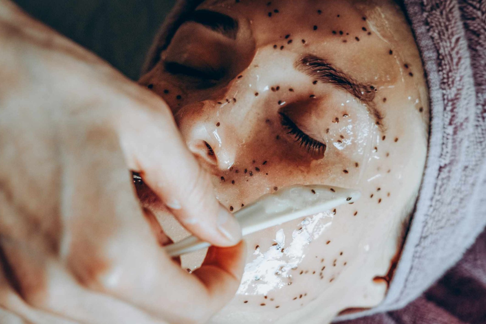 Woman applying flaxseed face mask